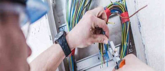 Technician wiring an automated gate control system