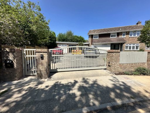 Powder coated steel driveway gate with pedestrian gate installed by IGS Systems