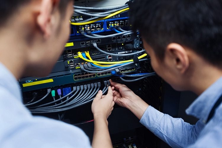 Technician performing maintenance on a control panel