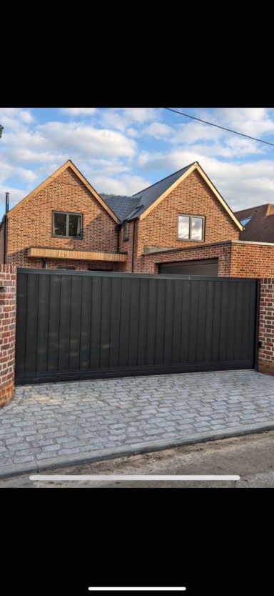 Bespoke black steel driveway gates installed by IGS Systems